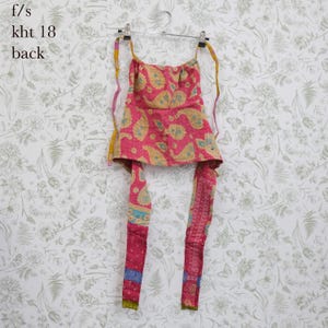 May include: A pink and yellow paisley print halter top with thin straps and long ties hanging down. The fabric features a quilted texture with visible stitching. The text f/s kht 18 back is printed in the upper left corner of the image.