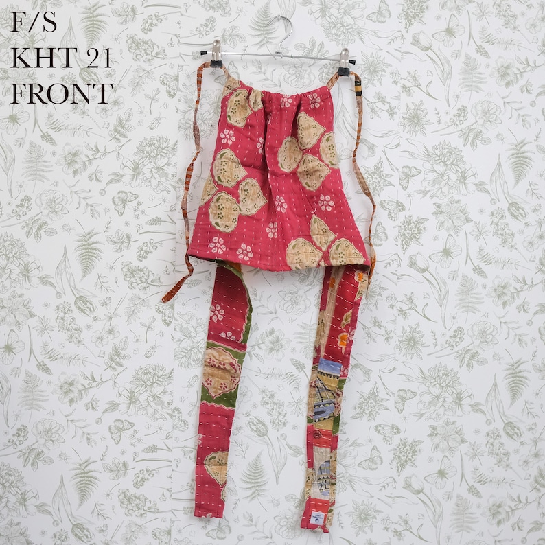 May include: A red quilted halter top featuring a floral pattern in beige and green, with long fabric ties and visible white stitching. The text F/S KHT 21 FRONT is printed in the upper left corner of the image, indicating the garment orientation.