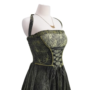 May include: A dark charcoal gray halter dress featuring a lime green lace bodice overlay, black corset-style lace-up front detailing, and lime green floral embroidery on the sides. The garment includes a thin gold-toned necklace with a pendant.