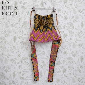 May include: A sleeveless halter top featuring a black and yellow floral upper section, a pink and yellow zigzag patterned middle, and long, multicolored patterned ties. The text F/S KHT 20 FRONT is visible in the upper left corner of the image.