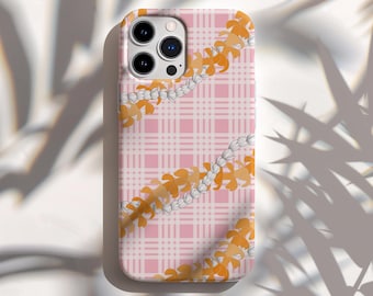 May include: A pink phone case with a plaid pattern and a floral design. The case features a repeating pattern of orange and white flowers, creating a tropical aesthetic. The case has a camera cutout.