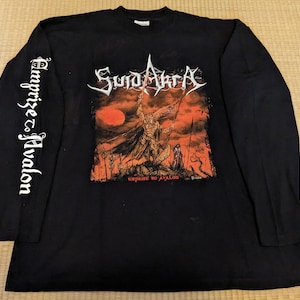 May include: Black long-sleeve t-shirt with a graphic print of a band called "Sunn O)))  " with the text "Emprise to Avalon" on the front and the same text on the left sleeve.