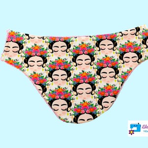 Peut inclure: Sous-vêtements rose et blanc avec un motif répété d'un visage de femme avec des fleurs. Le texte "Lilo Telitas Hand Made" est dans le coin inférieur droit.