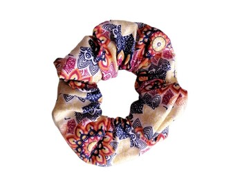 May include: A yellow, red, and blue patterned scrunchie with a floral design.