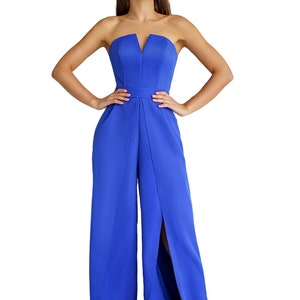 May include: A royal blue strapless jumpsuit with a V-neckline and a front slit on each leg.