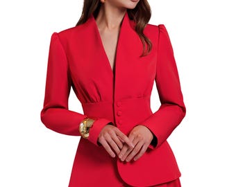 May include: A vibrant red suit featuring a tailored blazer with a notched collar and three-button closure, paired with a matching skirt. The ensemble is accessorized with a gold bracelet and earrings. The outfit is a bold statement in formal wear.