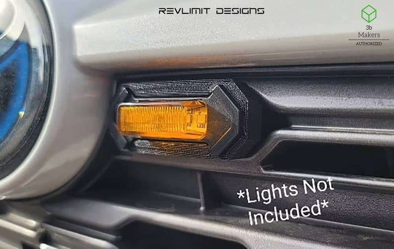 May include: A black plastic car part with an orange light. The part is designed to fit on a car's front bumper. The text "*Lights Not Included*" is printed on the car's bumper.