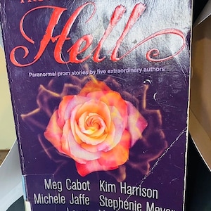 May include: Book cover with a purple background and a pink rose. The title is "Prom Nights From Hell" in red lettering. The subtitle is "Paranormal prom stories by five extraordinary authors". The authors listed are Meg Cabot, Kim Harrison, Michele Jaffe, Stephenie Meyer, and Lauren Myracle.
