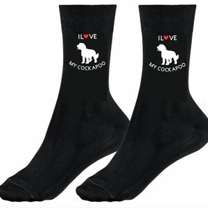May include: A pair of black socks with a white silhouette of a Cockapoo dog and the text "I Love My Cockapoo" on the front. The socks have a red heart in the text.
