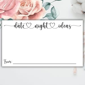 May include: A white card with the text "date night ideas" in black cursive writing. There is a small heart symbol between each word. The card has a line for "From:" at the bottom.