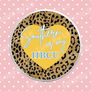 May include: Round coaster with a gold leopard print border and a yellow heart in the center. The heart contains the text "Southern is my HBCU" in light blue script. The coaster has a white border and is set against a pink background with white polka dots.