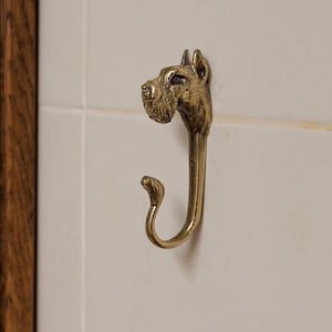 Miniature Schnauzer — a wall hook in the shape of a Miniature Schnauzer dog, made of brass, strong, and durable.
