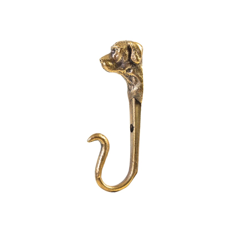 May include: A gold-toned metal hook with a dog's head design. The hook is shaped like a 'J' with a rounded end.