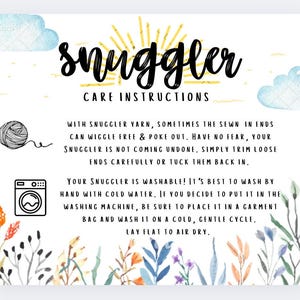 May include: A care instructions card with the word "snuggler" in cursive script. The card includes text about washing instructions, a yarn ball illustration, and a washing machine icon. Floral and cloud illustrations decorate the edges.