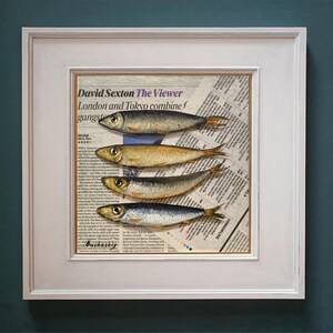 May include: A framed print of a newspaper clipping with the title "The Viewer" by David Sexton. The clipping features a painting of five silver fish arranged in a row on a newspaper background.