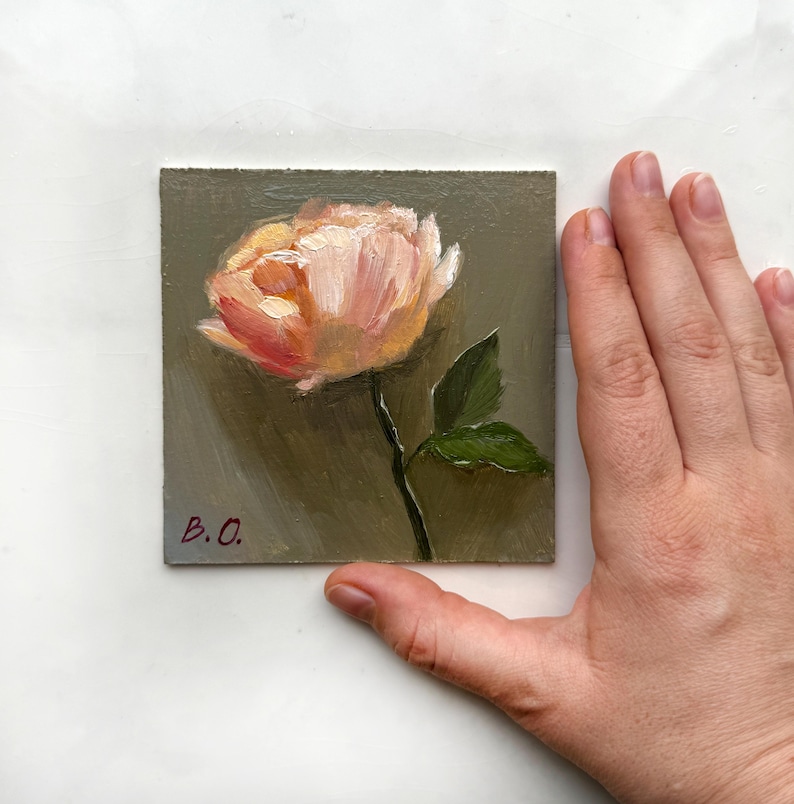 May include: A small painting of a single pink flower with green leaves on a gray background. The painting is signed "B.O."