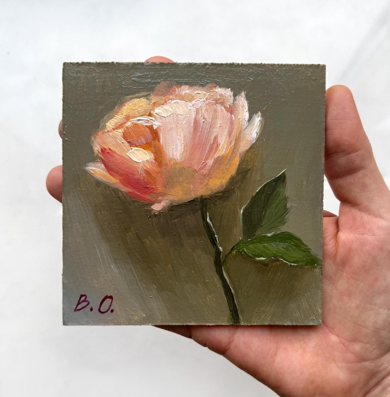 May include: A small painting of a single pink flower with green leaves on a dark green background. The painting is signed "B.O."