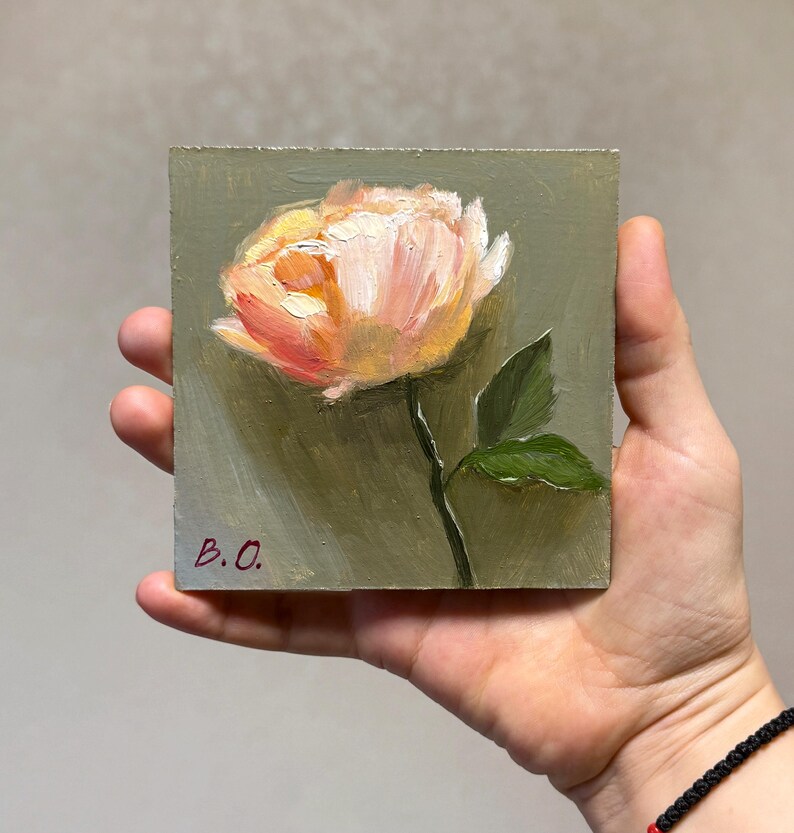 May include: A small painting of a single peach-colored rose with green leaves on a green background. The painting is signed "B.O."