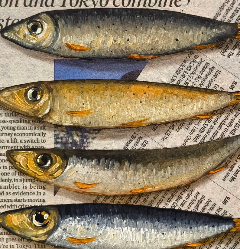May include: A close-up of five silver and gold fish painted on a newspaper background. The fish are stacked on top of each other, with the tails of the fish at the bottom of the image and the heads of the fish at the top of the image.