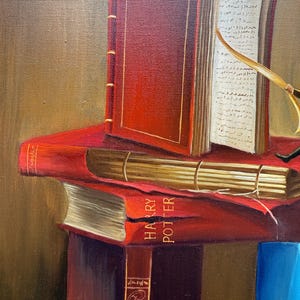 May include: A still life painting of a stack of books. The top book is open and has a red cover. The second book has a red cover and the words "HARRY POTTER" are visible on the spine. The bottom book is partially visible and has a red cover.