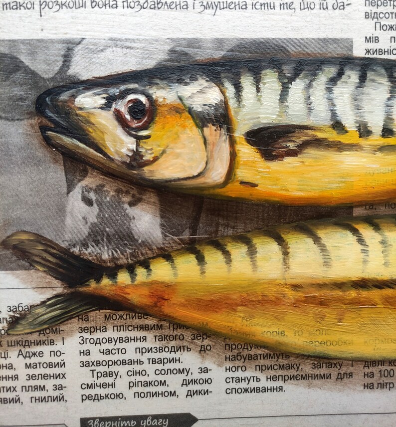 May include: An oil painting of two mackerel fish, showcasing yellow, black, and silver hues. The fish are positioned on a newspaper background, with visible text fragments. The artwork captures the texture and details of the fish.