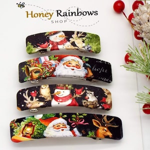 May include: Four Christmas-themed barrettes with festive designs. Each barrette features a different holiday scene, including snowmen, Santa Claus, reindeer, and owls, set against a black background. The barrettes are rectangular with a metal clasp.