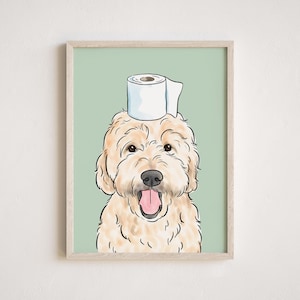 May include: A light brown dog with a white toilet paper roll on its head. The dog is smiling with its tongue sticking out. The background is a light green color.