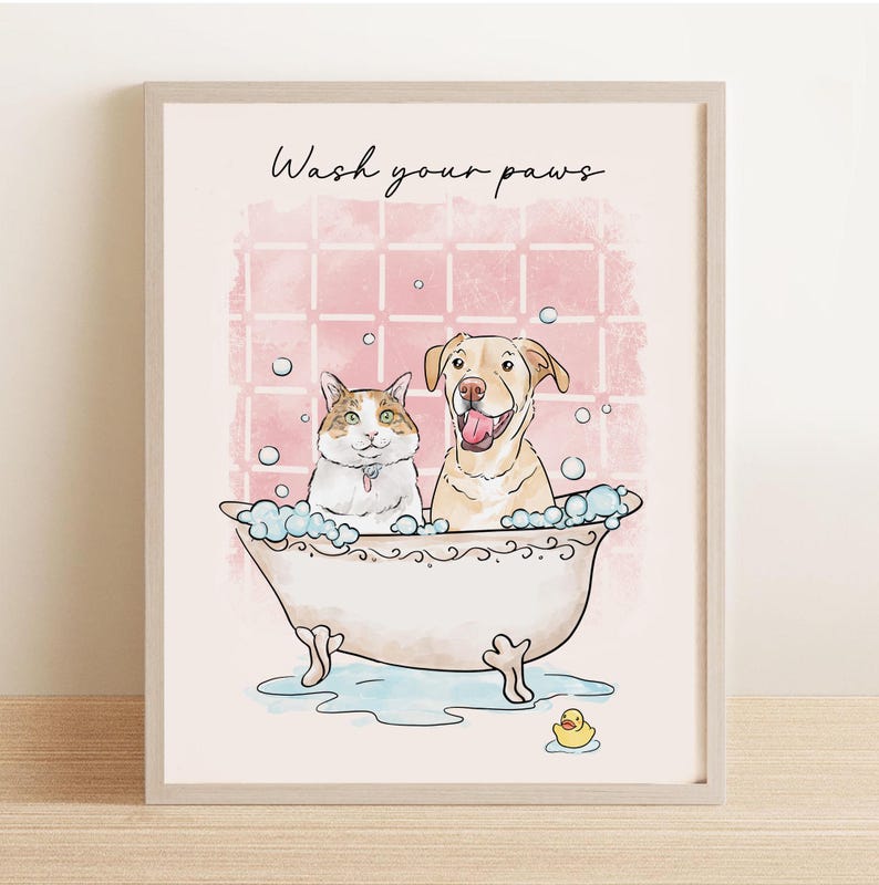 May include: A framed print featuring a cat and a dog in a bathtub with bubbles. The text "Wash your paws" is written above the animals. A yellow rubber ducky is in the water. The background is pink.