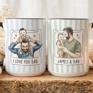 May include: Two ceramic mugs with black handles. One mug has a blue and white striped pattern with the text "I LOVE YOU DAD" and a drawing of a father and child. The other mug has a green and white striped pattern with the text "JAMES & DAD" and a drawing of a father and child.