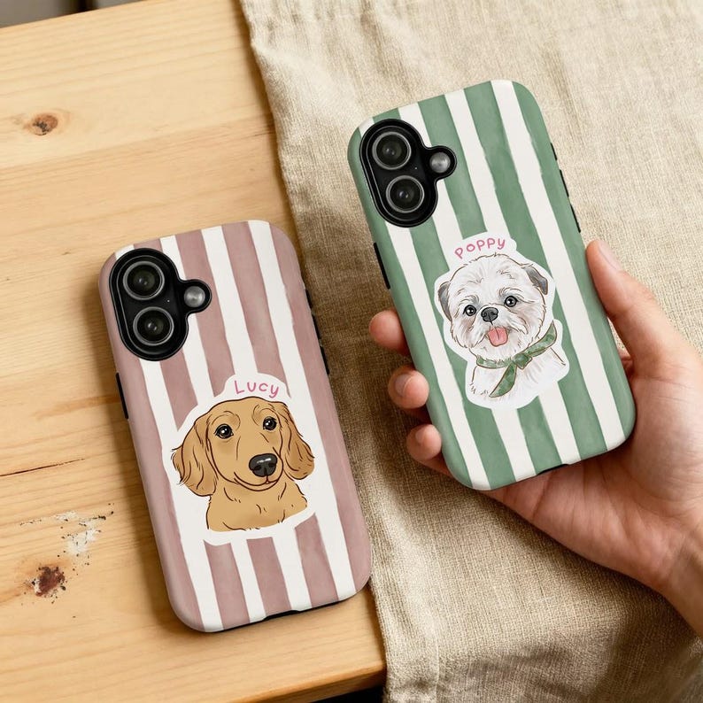 May include: Two phone cases with dog illustrations. One case has a dachshund with the name "Lucy" on a pink and white striped background. The other case has a white dog with the name "Poppy" on a green and white striped background.