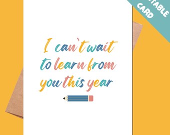 May include: A white printable card with the text "I can't wait to learn from you this year" in colorful script. A blue and pink pencil graphic is at the bottom. The card is on a brown envelope, with a teal corner that says "Printable Card".