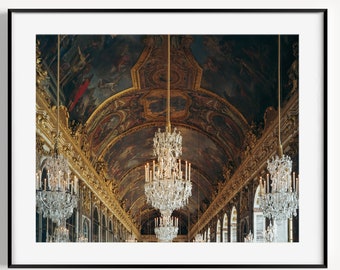 May include: A photograph of a grand hall with a high, ornate ceiling painted with a dark blue and gold design. The hall is lined with large windows and decorated with multiple crystal chandeliers.