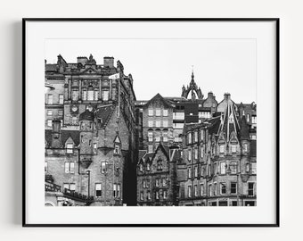 May include: Black and white photograph of a row of historic buildings in a city. The buildings are tall and narrow, with many windows and intricate details. The photo is taken from a low angle, looking up at the buildings.