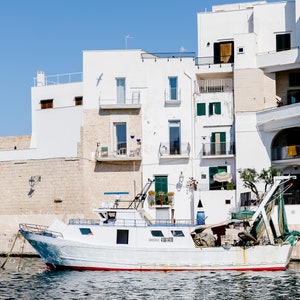 Coastal photography print of a boat in a marina in the town of Monopoli in Puglia, Italy.