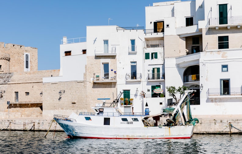 Coastal photography print of a boat in a marina in the town of Monopoli in Puglia, Italy.