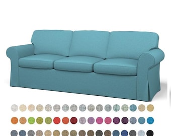 May include: A light blue sofa with a tufted back and rolled arms. The sofa is upholstered in a textured fabric. The image shows a variety of fabric swatches in different colors.