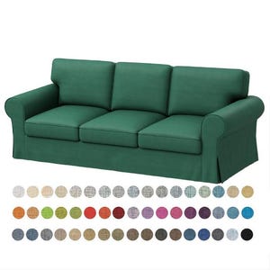May include: A three-seater sofa with a dark green fabric cover. The sofa has a tufted back and rolled arms. The sofa is shown against a white background.