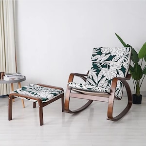 May include: A rocking chair with a green and white floral patterned cushion and a matching footstool. The chair and footstool are made of wood and have a dark brown finish.