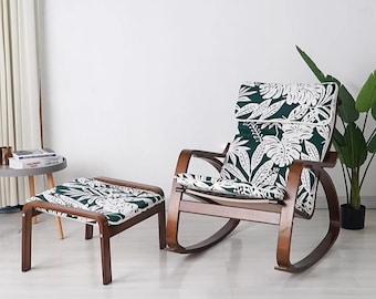 May include: A rocking chair with a green and white floral patterned cushion and a matching footstool. The chair and footstool are made of wood and have a dark brown finish.