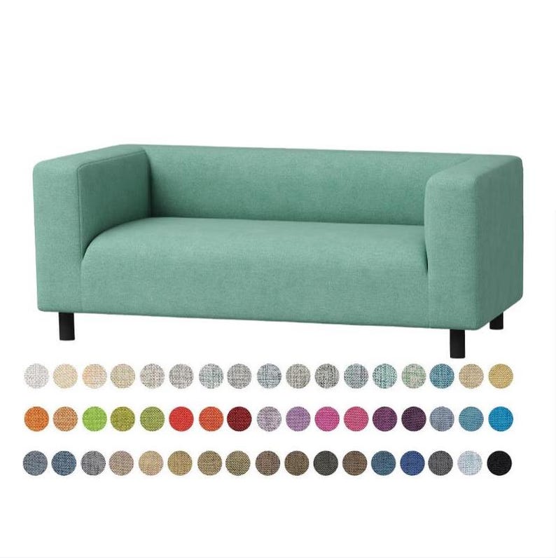 May include: A mint green two-seater sofa with a rectangular backrest, integrated armrests, and four short black legs. Below the sofa, a grid of seventy-two small circular fabric swatches displays a wide variety of available solid colors and textures.