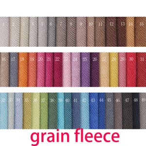 May include: A fabric swatch display featuring forty-nine vertical strips of textured grain fleece material in a wide spectrum of colors, each labeled with a white number from 1 to 49. The text "grain fleece" is printed in red at the bottom.