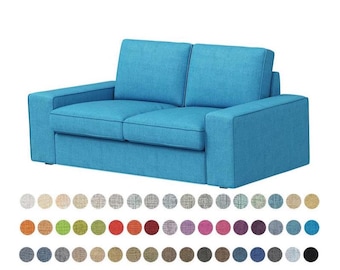 May include: A light blue two-seater sofa with a tufted back and armrests. The sofa is made of fabric and has a modern design.