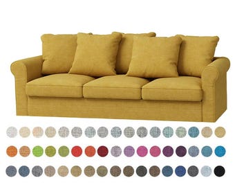 May include: A three-seat sofa in a golden yellow color, featuring three seat cushions and four matching back cushions. The sofa has rolled arms and a skirted base. A color swatch of fabric samples is displayed below the sofa.
