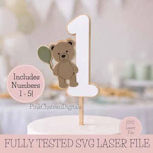May include: A wooden number one cake topper with a brown teddy bear holding a green balloon. The number is white with a wooden border. Text on the image includes "Includes Numbers 1-5!" and "PinkChateauDigitals".