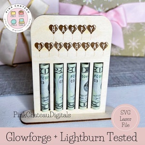 May include: A wooden birthday money holder with the words "Happy Birthday" spelled out with heart-shaped balloons. The holder has five slots for rolled up bills. The holder is made of natural wood and has a light brown color.