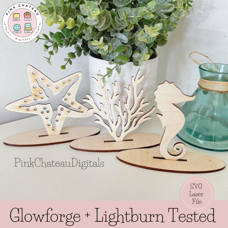 May include: Three wooden cutouts of a starfish, coral, and a seahorse. Each cutout is on a separate oval base. The cutouts are light brown and have a natural wood finish. The text "Glowforge + Lightburn Tested" is at the bottom of the image.
