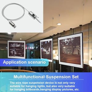 May include: A silver wire rope suspension kit with a screw and a metal clasp. The image shows the kit in use, suspending framed pictures. Text on the image reads "Multifunctional Suspension Set".