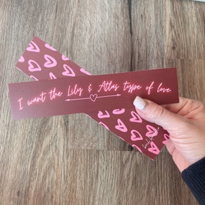 May include: Two burgundy bookmark-style cards with pink hearts and the text "I want the Lily & Atlas type of love" with a pink heart and arrow.