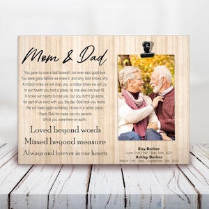 May include: A wooden plaque with a photo of an older couple, a poem about love and loss, and the names Ray Barber, 21st June 1945 - 16th May 2021 and Ashley Barber, 13th March 1948 - 20th September 2020.