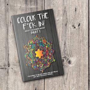 May include: A coloring book cover with a colorful mandala design and the title "COLOUR THE F*CK IN!"  Adult Coloring Book! Part 1.  The text below the mandala reads "Colouring to relieve stress and help relax (but with fun adult words)".